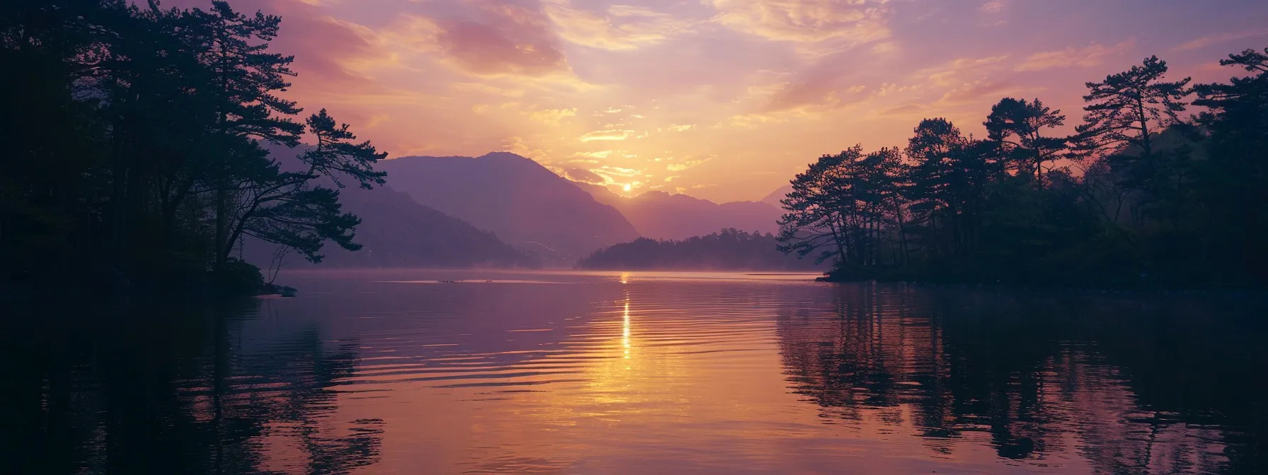 a breathtaking sunset over a tranquil lake, with vibrant orange and purple hues reflecting off the water’s surface, framed by silhouette trees along the shoreline.