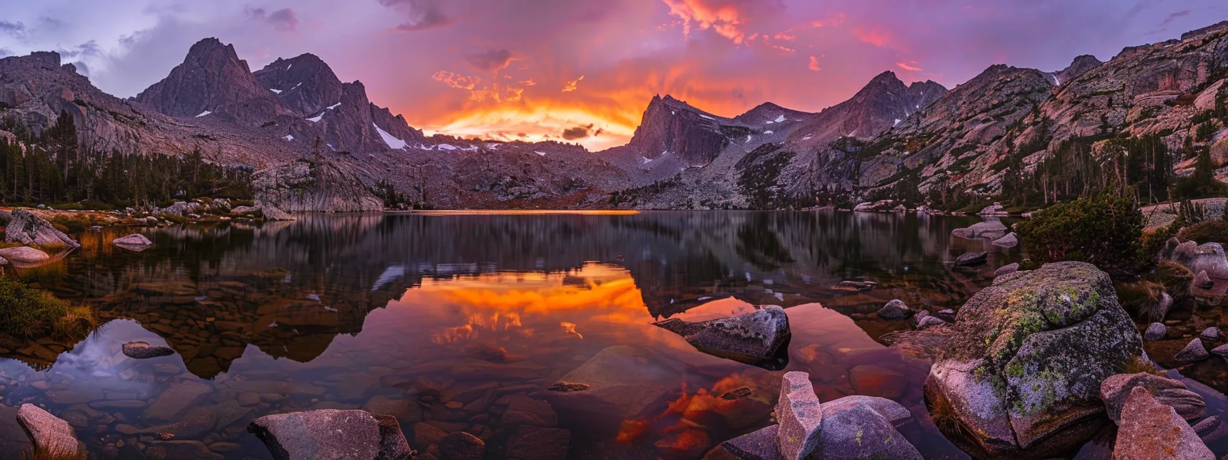 a vibrant sunset paints the sky in rich hues of orange and purple, casting a warm glow over a serene lake surrounded by towering mountains, creating a breathtaking reflection on the water's surface.
